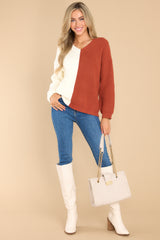 This ivory ginger sweater features a v-neckline, ribbed detailing throughout, and a two tone color blocking.