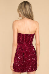 Back view of this dress that features a zipper down the back, boning in the bodice, faux velvet material, and all over sequin detailing.