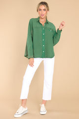 Full body view of this top that  features a collar neckline, button down bodice, and one front functional pocket.