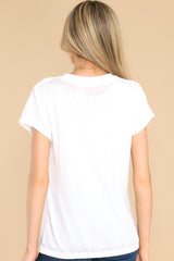 Back view of this tee that features a round ribbed neckline, folded sleeves, distressed detailing along the hems, and a lightweight washed fabric.