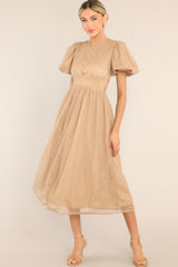 Front view of this dress that features a round tulle neckline, short puff sleeves, an open back with a four button closure, and a tulle flowy skirt.