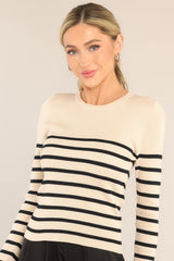 Front view of this top that features a crew neckline, a stretchy ribbed fabric, a striped pattern, and long sleeves.