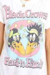 Close up view of this tee that features a round ribbed neckline and folded sleeves, and a graphic of The Black Crowes that says 