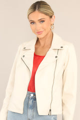 Ecru moto jacket with rhodium buttons on the collar, and an offset zipper up the front right side of the jacket.
