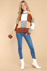 Full body view of this sweater that features a patchwork design.