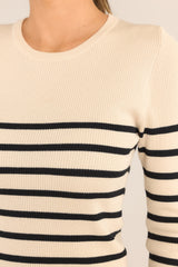 Close up view of this top that features a crew neckline, a stretchy ribbed fabric, a striped pattern, and long sleeves.