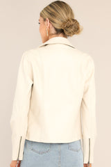 Back view of an ecru, faux leather moto jacket.