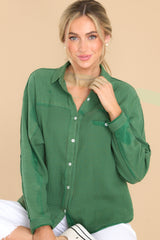 Front view of this top that  features a collar neckline, button down bodice, and one front functional pocket.