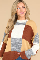 Front view of this sweater that features a crew neckline, patchwork design, and a cozy oversized fit.