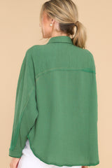 Back view of this top that  features a collar neckline, button down bodice, and one front functional pocket.