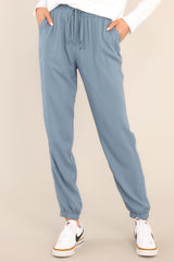 Front view of these joggers that feature an elastic waist with a self-tie drawstring, two functional waist pockets, an elastic ankle, and a lightweight breathable fabric.