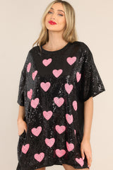 Front view of this tunic that showcases the pink heart pattern of the black fabric.