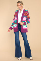 This multi-colored cardigan features a v-neckline, drop shoulders, four functional buttons down the front, two front pockets, cuffed sleeves, an intricate jacquard pattern, and a soft knit material throughout.