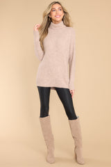 Full body view of this sweater that features long sleeves with ribbed cuffs and a bottom hem that tapers in around the hips.
