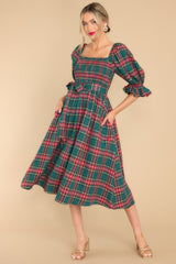  This charming green dress has a square neckline, fully smocked bust, a self-tie waist belt, functional pockets, elastic-cuffed sleeves, and an all-over plaid print, creating a delightful ensemble.