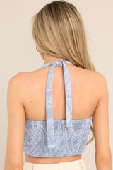 Back view of  this top that features a v-neckline, a pleated chest, a fully smocked back insert, and a self-tie feature at the back of the neck.