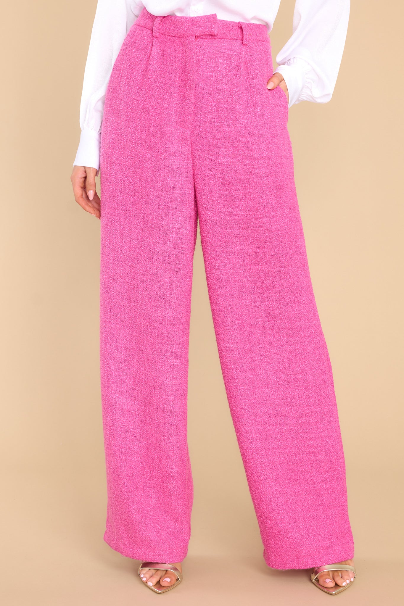 These hot pink pants feature a high waist, a hook and eye and zipper closure, functional belt loops, two functional front pockets, a faux back pocket, and a wide leg.