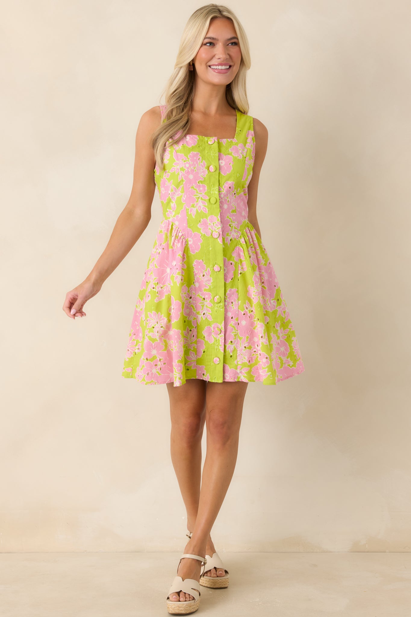 Vibrant floral mini dress with square neckline, tailored bodice, and flared skirt.