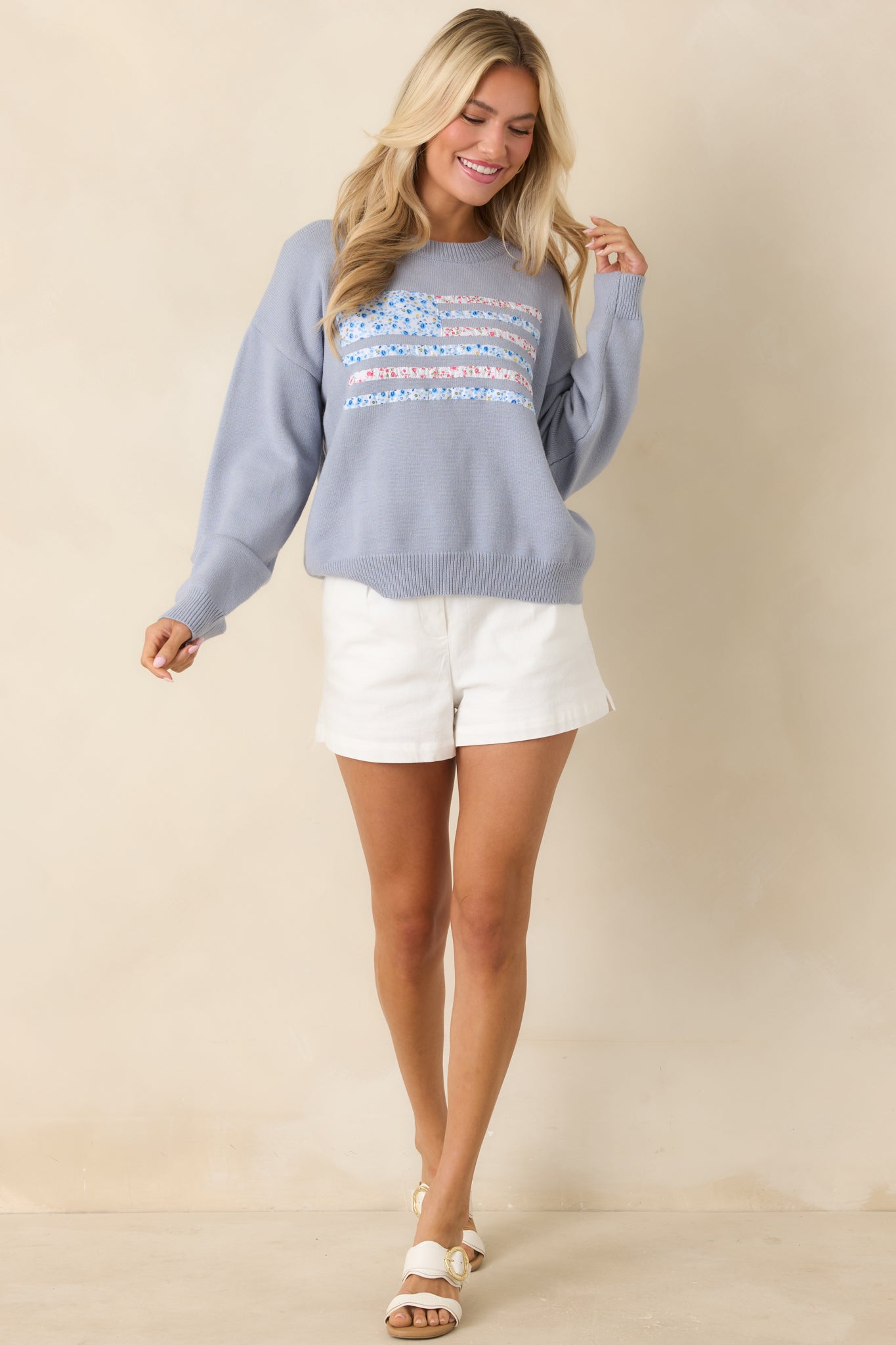 Front view of dusty blue knit sweater featuring relaxed fit, ribbed crew neckline, and long sleeves.