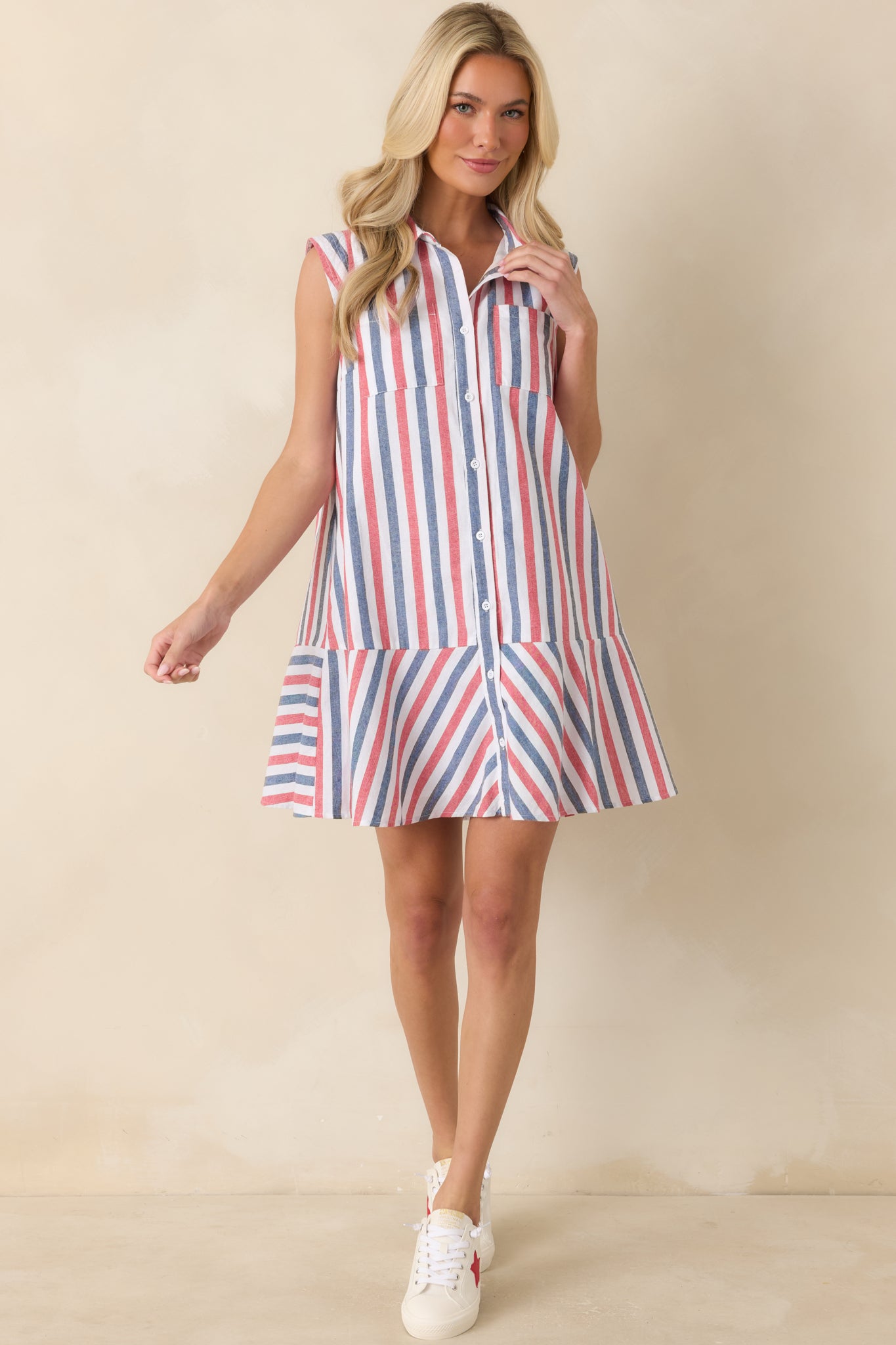 Red, white, and blue mini dress showcasing a relaxed fit, chest pocket details, and a lined cotton construction.