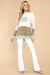 This mint and taupe striped sweater features a striped design, ribbed cuffs, and a soft fabric.