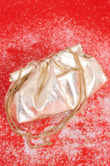 Top view of this bag that features a wide hinged opening that snaps shut (no zipper or snap button closure) , a non-removable gold chain strap, and one zipper pocket inside.