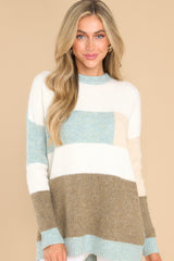 Front view of this striped sweater that features a striped design, and ribbed cuffs.