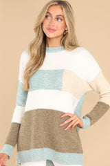 Front view of this striped sweater that features a striped design, ribbed cuffs, and a soft fabric.