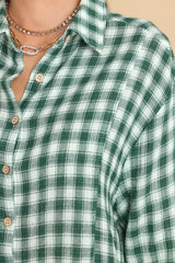 Close up view of this top that features a collared neckline and buttons down the front.