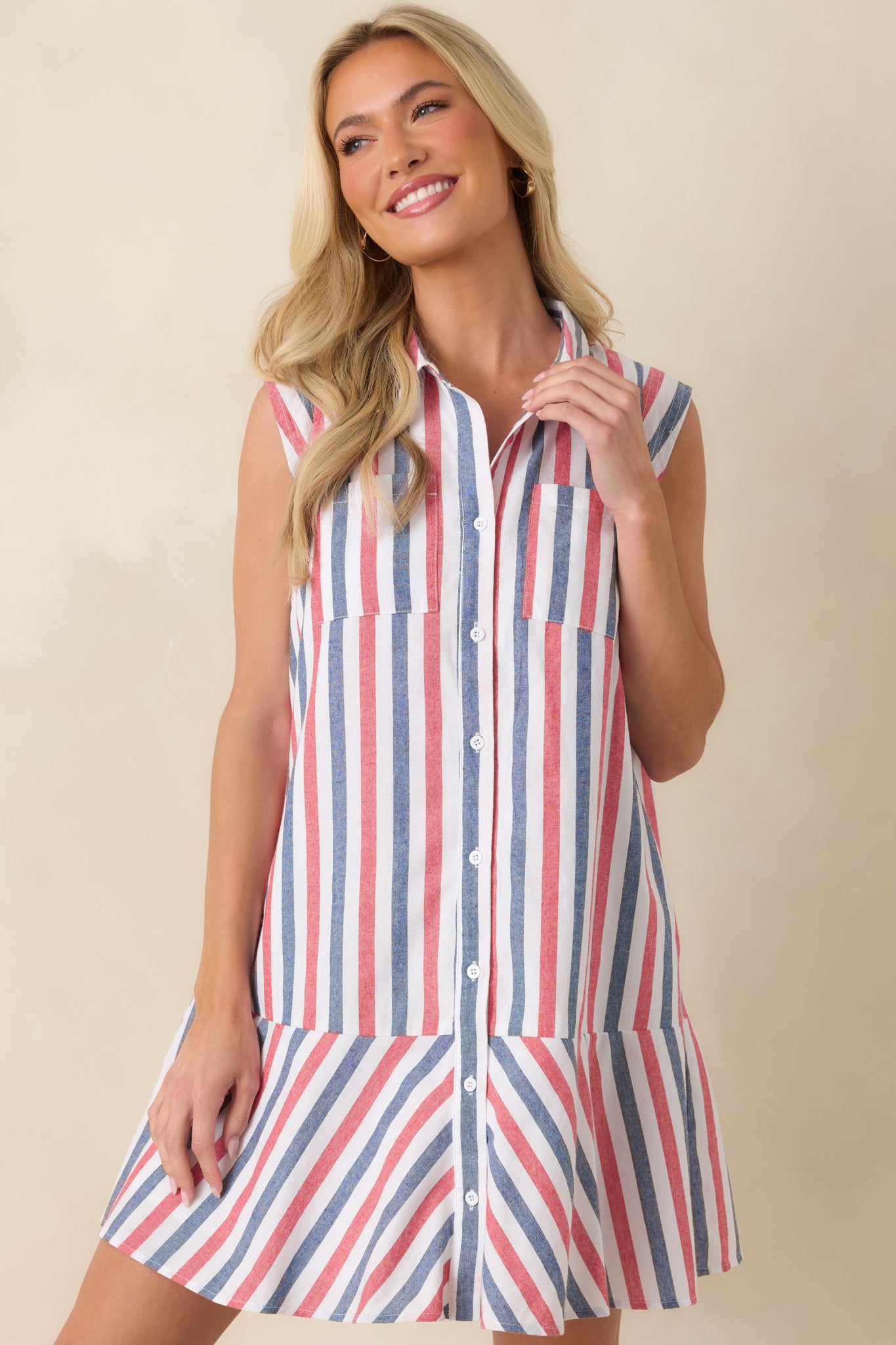 Detailed view of the striped mini dress emphasizing the button-front design and pocket accents.