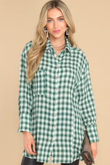 Front view of this top that showcases the plaid pattern of the fabric in shades of green.