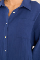 Detailed view of the breast pocket on this blue gauze midi dress.