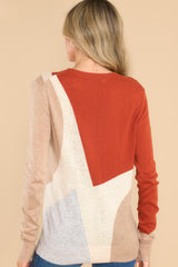 Back view of this sweater that features a crew neckline, ribbed cuffs and hem, a multi-colored geometric pattern, and a soft knit material.