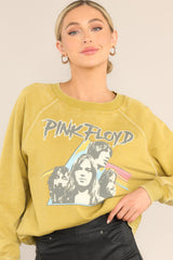 This mustard yellow sweatshirt features a ribbed crew neckline, exposed seams, graphic of the band members, 