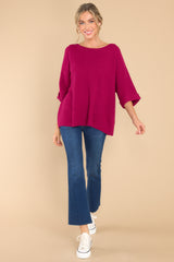 Full body view of  this top that features a round neckline, quarter sleeves with cuffed arms, and a chunky knit material. 