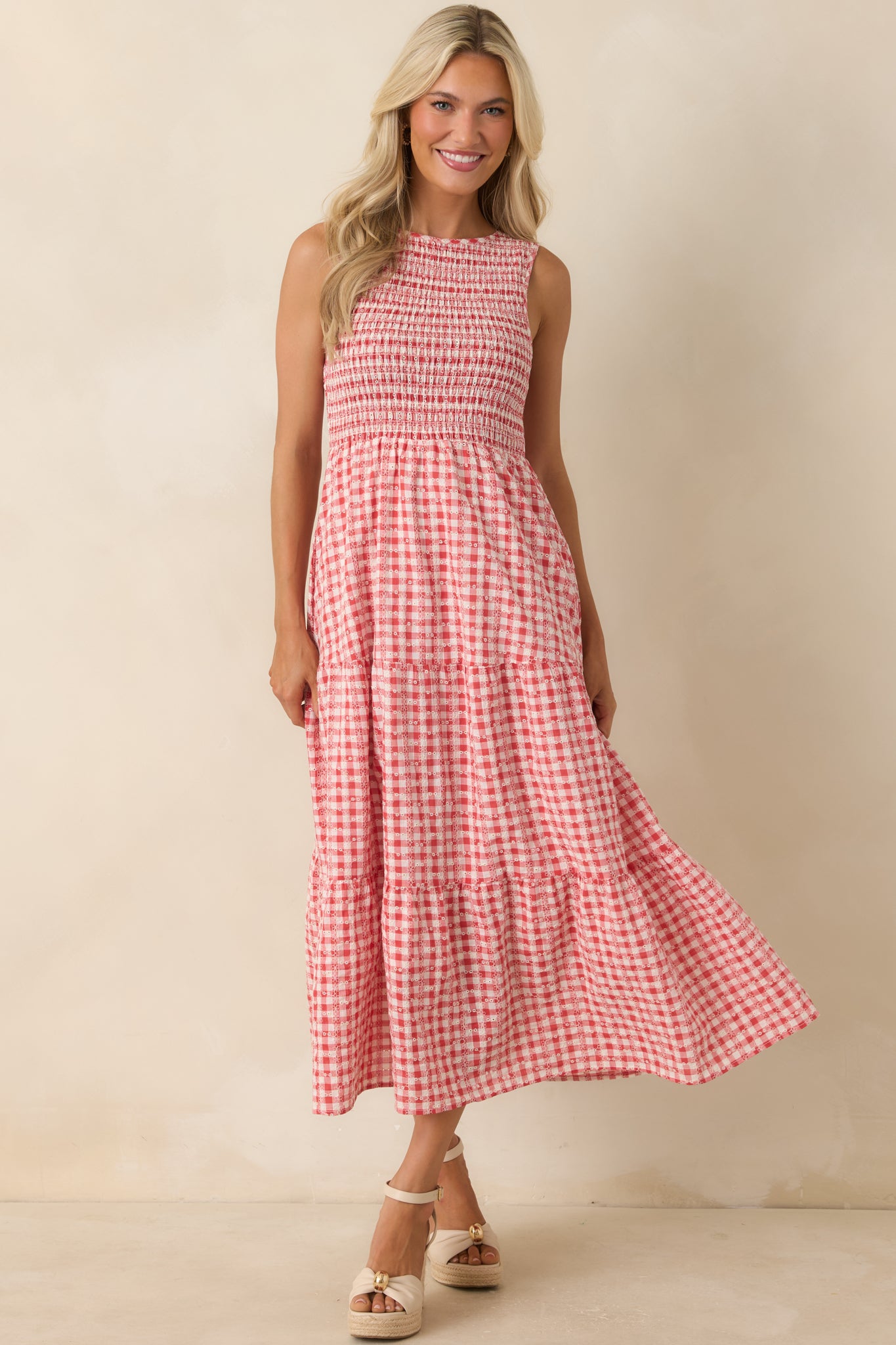 Red gingham dress showcasing hidden side pockets and a softly flowing tiered design.