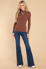 Full body view of soft long sleeve top with a mock neck. 