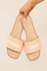 These pink sandals feature a a strap across the top of the foot with the name of a tropical location.