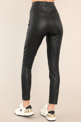 Back view of these pants that feature a high waisted pull-on design, an elastic waistband with hidden core shaping technology, faux front pockets, and functional back pockets.
