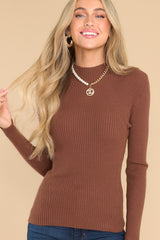Front view of brown mock neck, long sleeve top. 