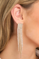 These gold earrings feature encrusted rhinestones all over, a square design with different lengths hanging down. 
