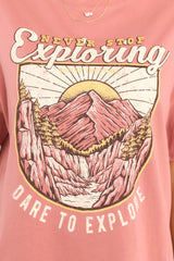 Close up view of this top that features a mountain graphic that says 