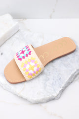 Top view of these sandals that feature a crochet detail over the foot.