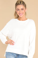 Front view of this sweater that features a scoop neckline and two slits at sides.