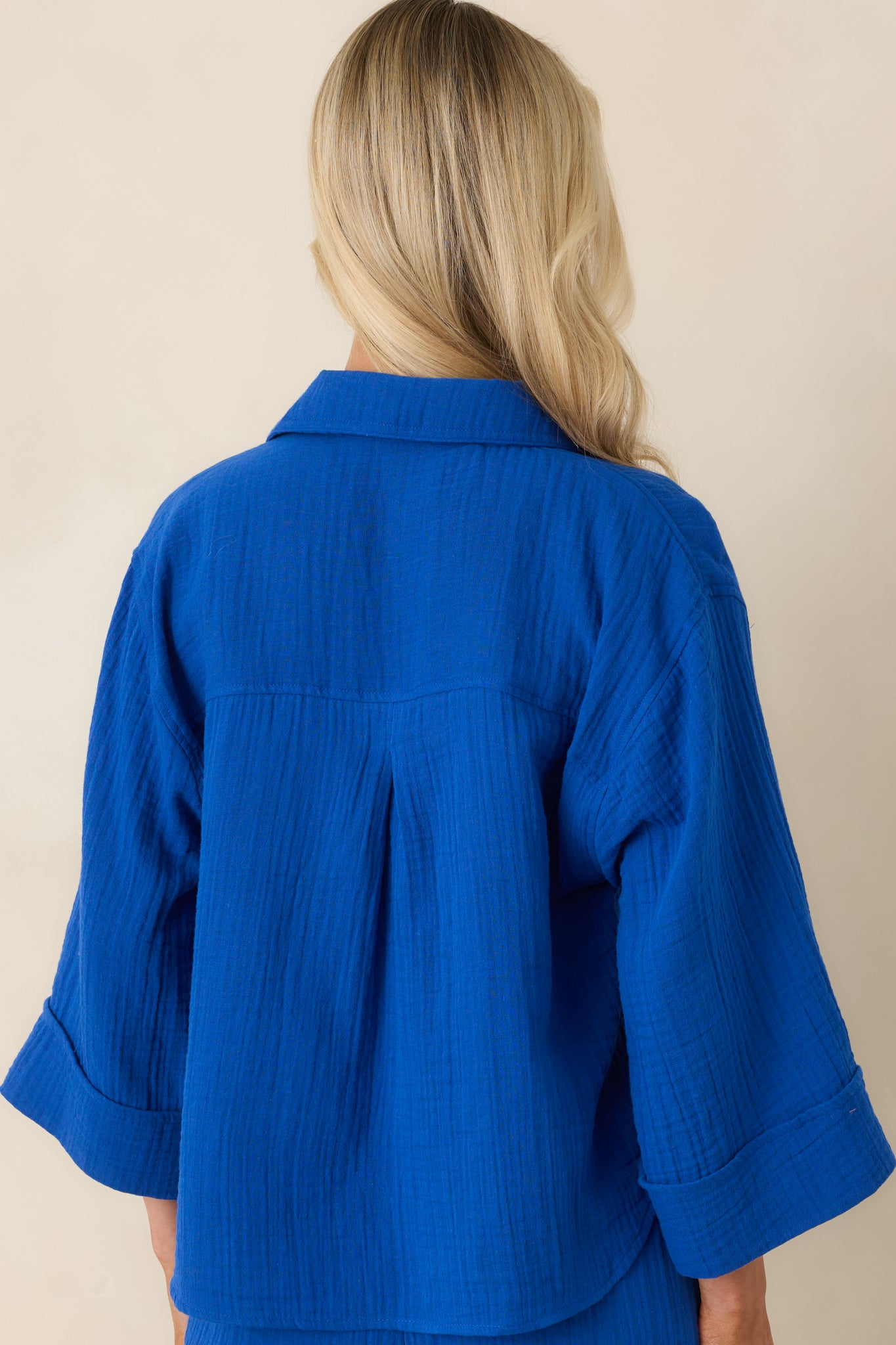 Back view of nautical blue cotton gauze button-up featuring a relaxed, slightly boxy silhouette and airy drape
