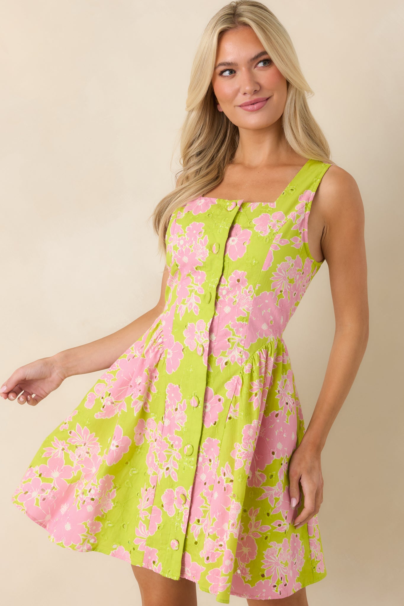 Button-front placket with tailored stitching and defined waist shaping.