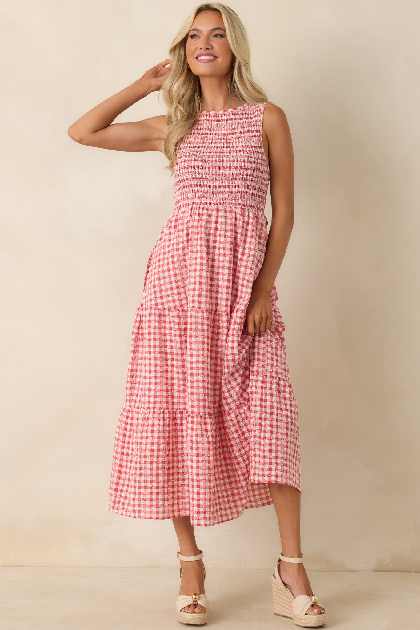 Midi-length gingham dress featuring structured smocking at the bust and airy skirt movement.