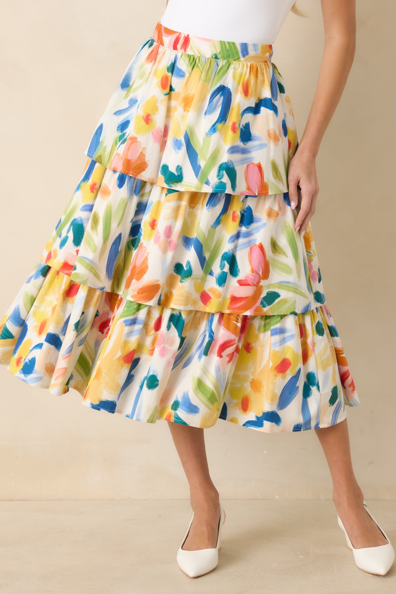 Closer view showing the flowy midi-length hem and colorful floral pattern.