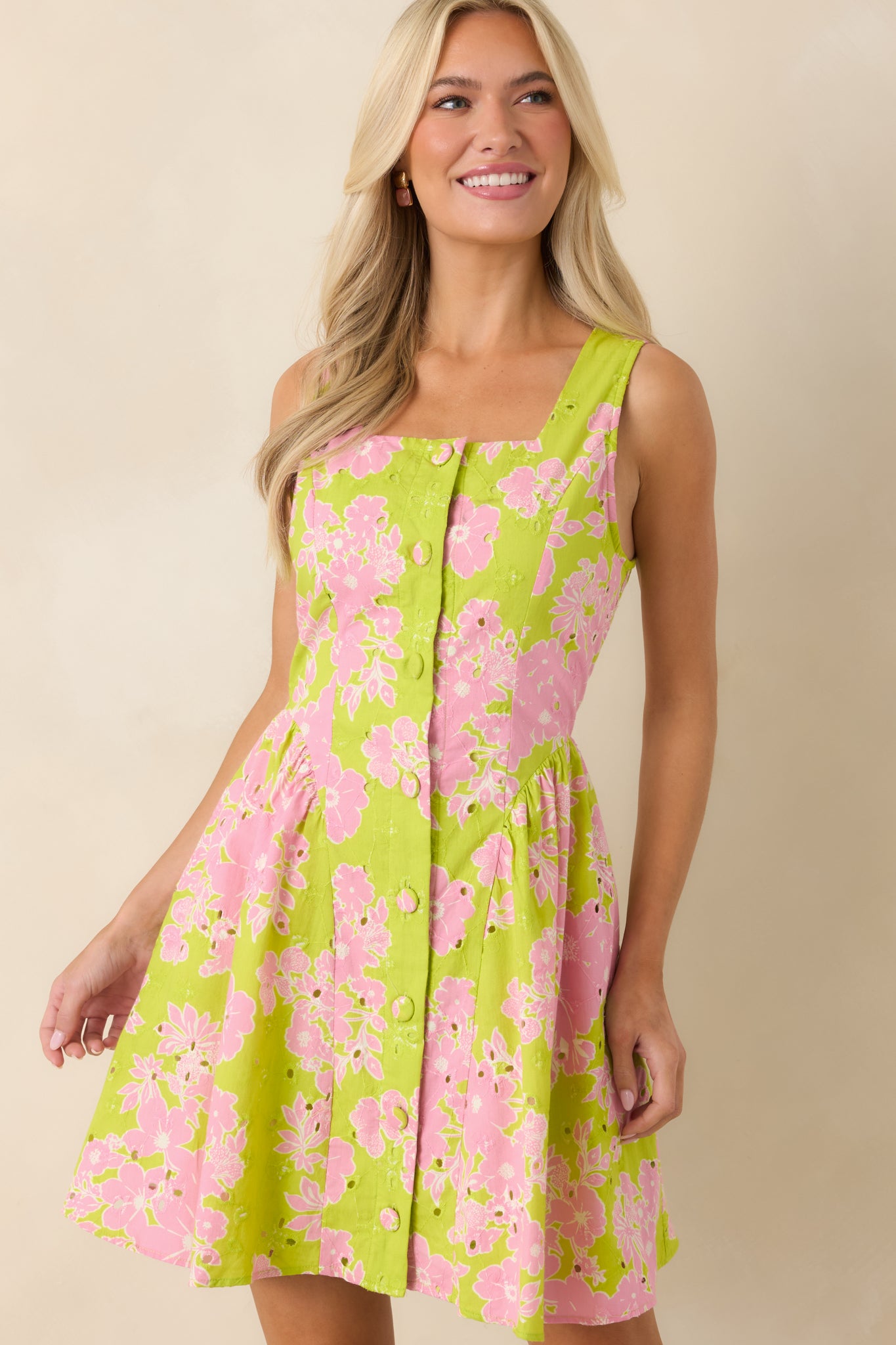 Close view of eyelet fabric with vibrant floral pattern and cotton texture.
