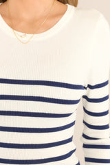 Close up view of this top that features a crew neckline, long sleeves, soft ribbed fabric, and classic stripe pattern.